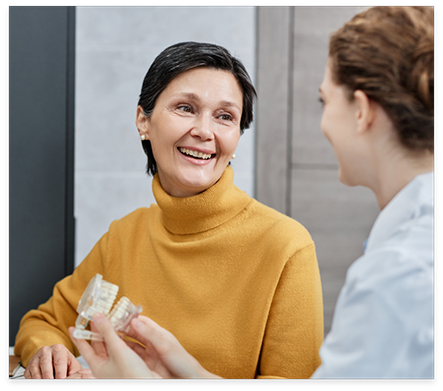 Dentist showing a model of the teeth to a patient