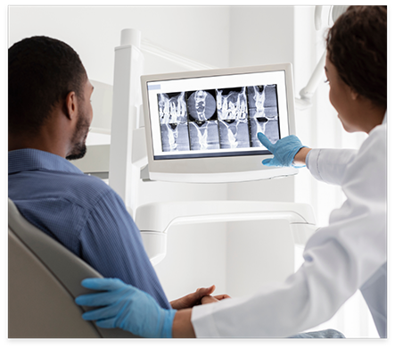 Dentist showing a patient digital x rays of their teeth