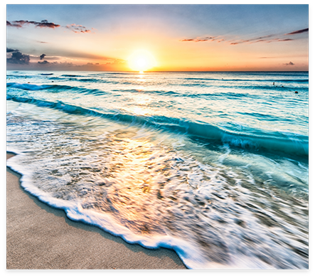 Waves on beach in late afternoon