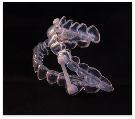 Clear oral appliance against black background