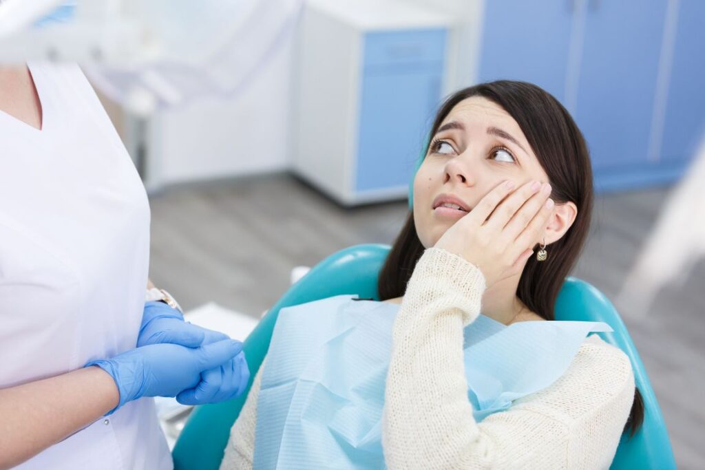 A woman in a dental chair with a toothache.